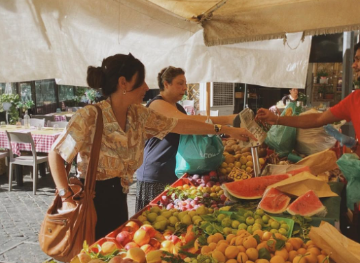 Shopper buying fresh fruit and vegetables at a farmers market